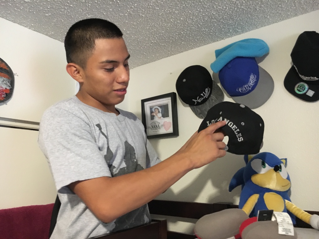 After Asylum Luis Gonzalez, 16, shows off his baseball hat collection in his room. He was granted asylum, along with his brother, Alejandro, in 2016.