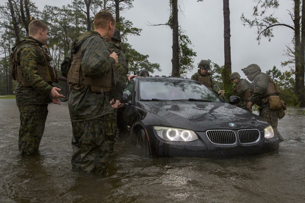 American Homefront Pentagon Sea Level Marines help push a car out of a flooded area at Camp Lejeune, N.C. during Hurricane Florence Sept. 15, 2018. The storm caused billions of dollars in damage to the base.