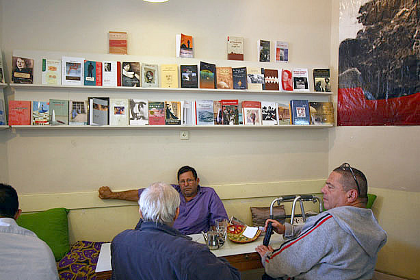 Uri Grosman sits with his friends at Café Yafa. Every Saturday they gather at the cross-cultural cafe to discuss politics and philosophy. Though they seek out the pluralistic atmosphere at Yafa, their hopes for coexistence only go so far.