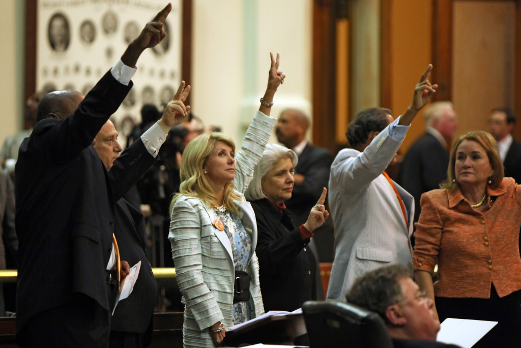 Protesters In Texas Statehouse Block Texas Lawmakers From Passing Abortion Bill State Sen. Wendy Davis (D-Ft. Worth) (3L) holds up two fingers against the anti-abortion bill SB5, which was up for a vote on the last day of the legislative special session June 25, 2013 in Austin, Texas.