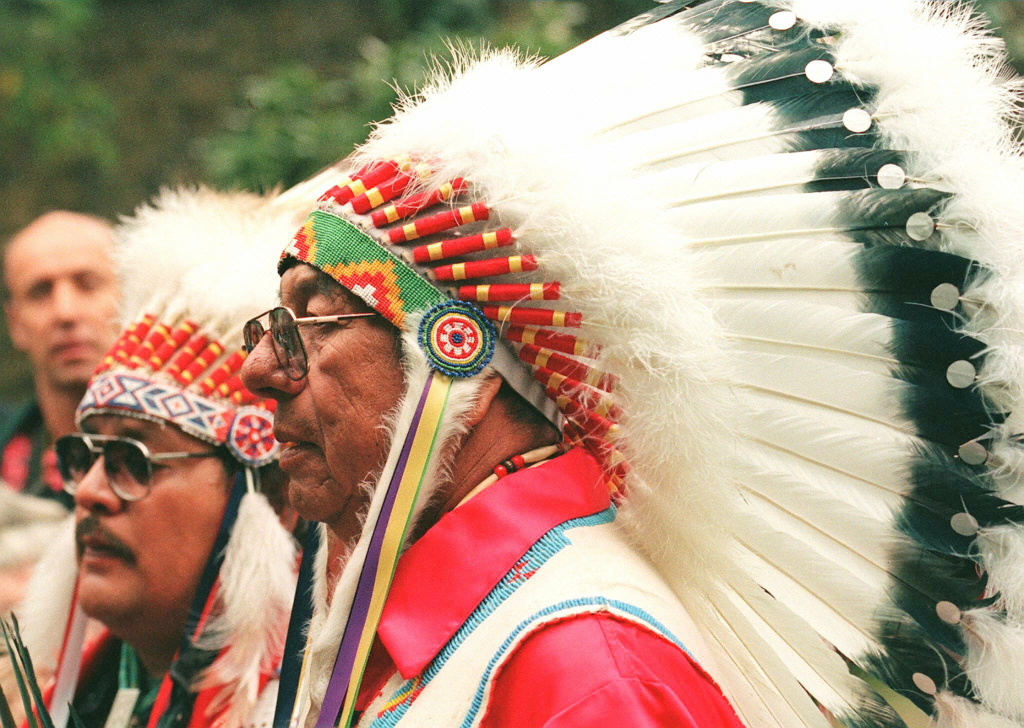 John Black Feather, a great-grandson of Long Wolf, John Black Feather, a great-grandson of Long Wolf, bedecked in an eagle-feather headdress, stands with other members of his Oglala tribe family, as the casket containing the remains of Long Wolf are carried from a London cemetery to be transported back to his tribal homeland in the Black Hills of Dakota.