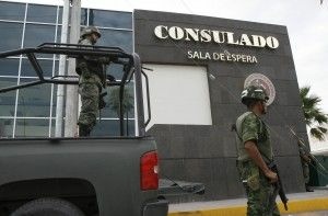 Mexican soldiers guard one of the entrances in July 2010 to the U.S. consulate in Ciudad Juarez, Mexico, where Mexican nationals married to U.S. citizens are typically sent to apply for visas to return legally. Under current rules, many get stuck there long-term.