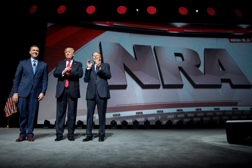 US-POLITICS-TRUMP-NRA US President Donald Trump stands with National Rifle Association (NRA) President Wayne LaPierre (right) and NRA-ILA Executive Director Chris Cox (left) during the NRA Leadership Forum in Atlanta, Georgia on April 28, 2017.