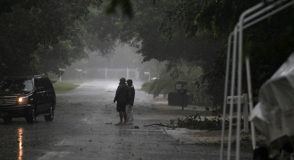 Isaac Bears Down On Florida Keys People stand near downed branches as Tropical Storm Isaac begins to move ashore on August 26, 2012 in Marathon, Florida.