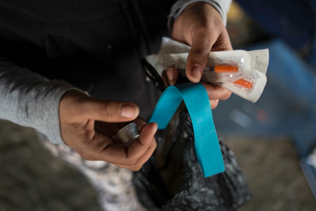 US-HEROIN-CRISIS-OPIOID-CRIME Jessica, a homeless heroin addict, shows her kit of clean needles, mixing cap and tourniquet in the Kensington neighborhood of Philadelphia, Pennsylvania, on April 14, 2017.