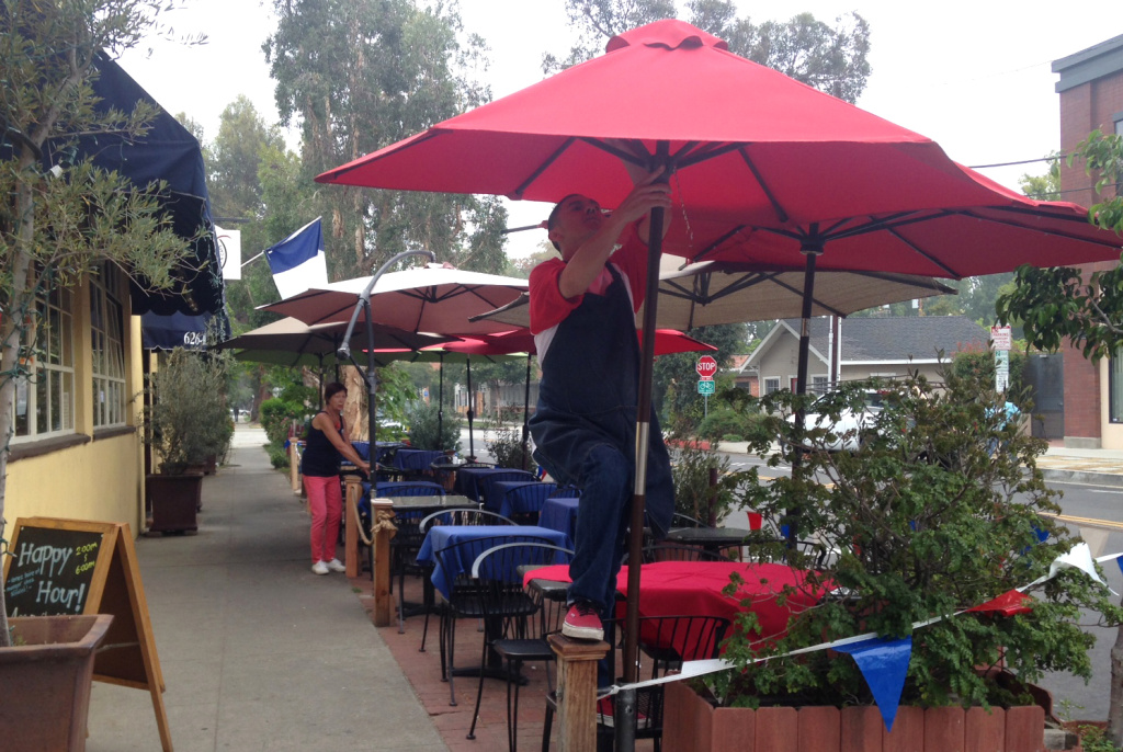 Nicole Grandjean (background left) and a colleague set up for their Bastille Day celebration outside Nicole's Gourmet Market and Cafe in South Pasadena on July 15, 2016. Nicole Grandjean (background left) and a colleague set up for their Bastille Day celebration outside Nicole's Gourmet Market and Cafe in South Pasadena on July 15, 2016.