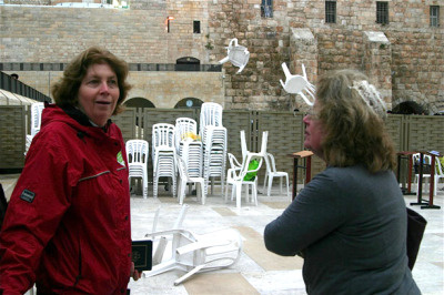 Anat Hoffman of Women of the Wall laughs as ultra-Orthodox men throw chairs over the separation screen at the Western Wall as the women prepare to pray. It is a felony for women to pray aloud in a group, wear a prayer shawl and read the Torah at the Western Wall because it is considered offensive to the Orthodox rabbinate which governs the site.