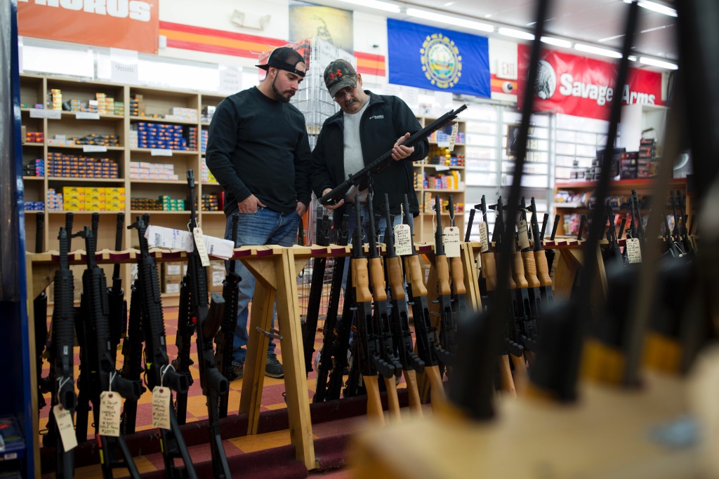 US-VOTE-ELECTION-GUNS Customers look at a long gun at a gun shop on November 5, 2016, in Merrimack, New Hampshire.