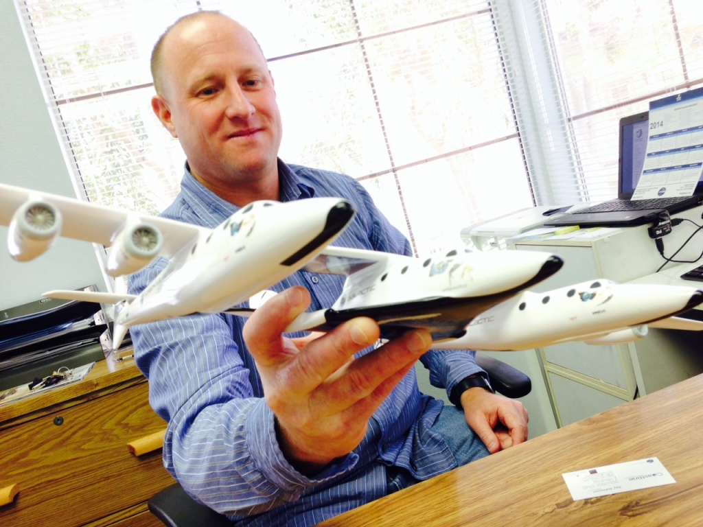 Jay Johnson Accredited Space Agent Jay Johnson holding a model of the ship Virgin Galactic will use to take tourists into space.