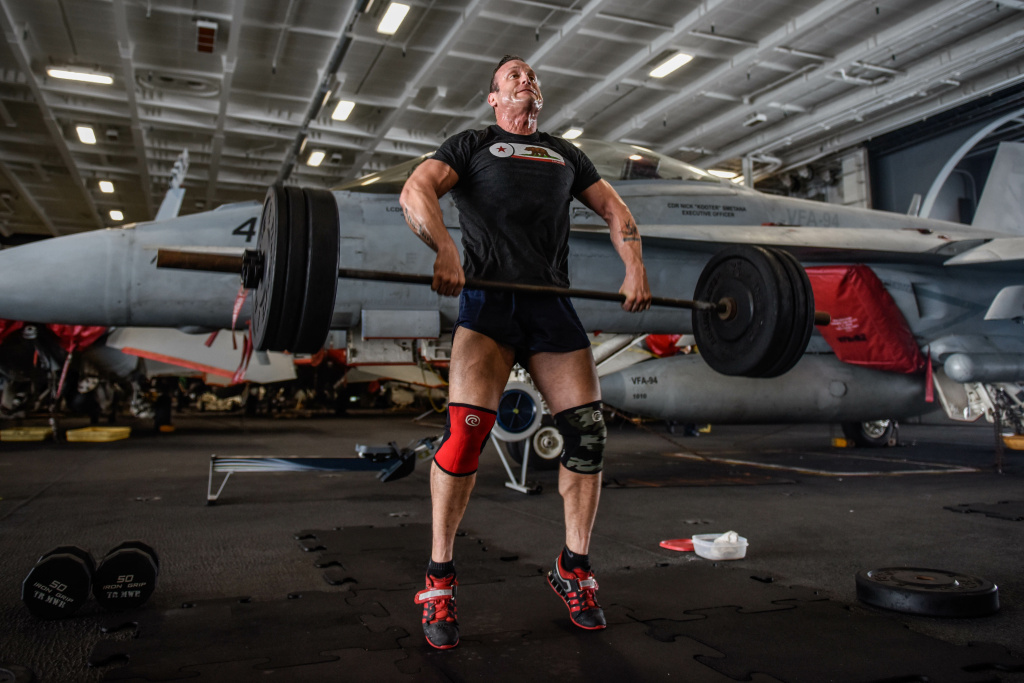 Lt. Joshua Johnson lifts weights USS Theodore Roosevelt (March. 2, 2018) Lt. Joshua Johnson lifts weights in the hangar bay of the aircraft carrier USS Theodore Roosevelt (CVN 71).