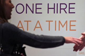 Satila Higgins, of Evansville, Ind., speaks with a prospective employer at a career fair in San Diego.
The Labor Department said Thursday that weekly applications for unemployment benefits fell 29,000 last week to a seasonally adjusted 343,000, the lowest in two months. It is the second-lowest total in 2012.