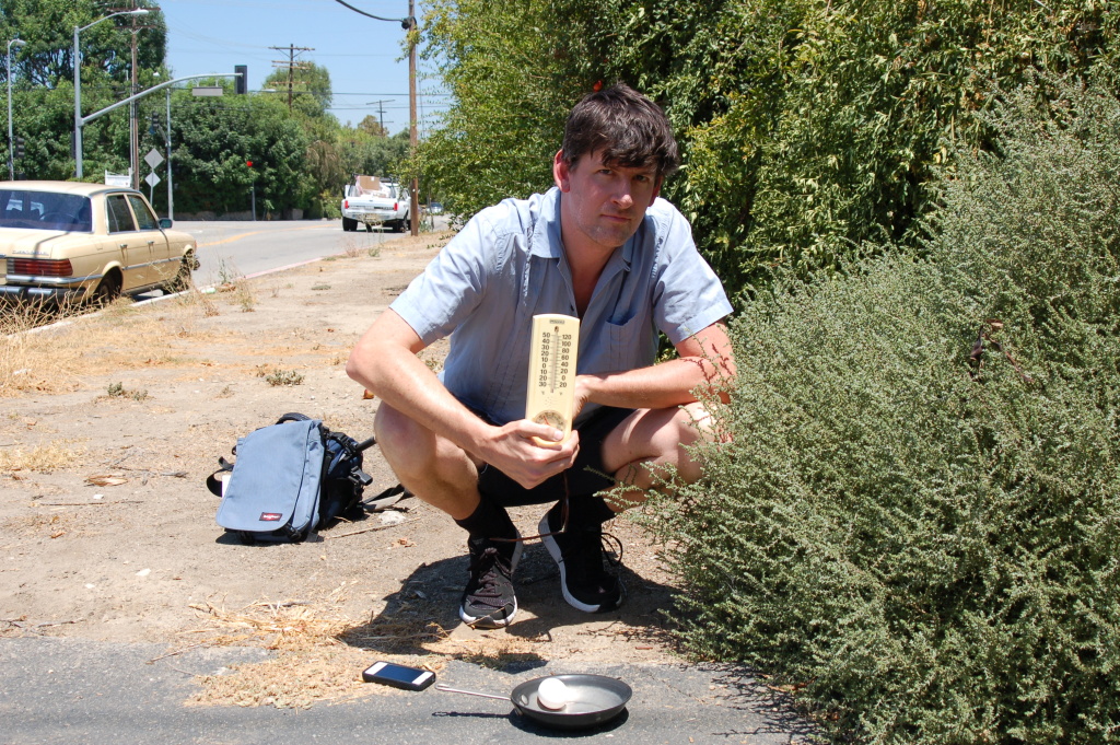 KPCC's John Rabe in Sherwood Forest preparing to fry an egg on the sidewalk. KPCC's John Rabe in Sherwood Forest preparing to fry an egg on the sidewalk.
