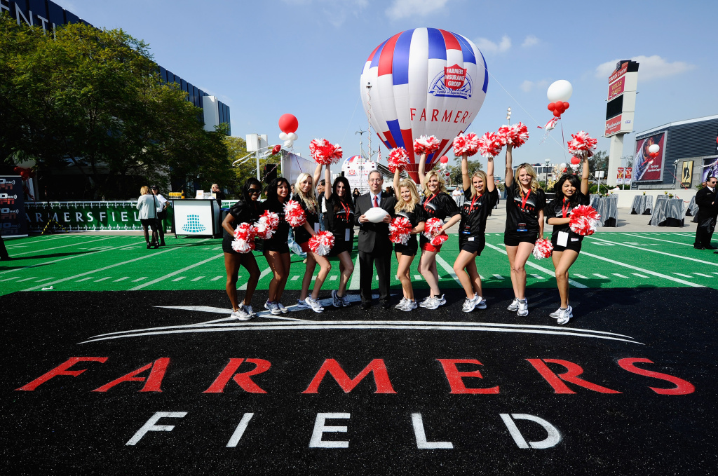 L.A. Event Center and NFL Stadium Press Conference LOS ANGELES, CA - FEBRUARY 01: Farmers Insurance Exchange executives Paul Patsis (C) with cheerleaders after an event announcing naming rights for the new football stadium Farmers Field at Los Angeles Convention Center on February 1, 2011 in Los Angeles, California. AEG has now dropped plans for the stadium.
