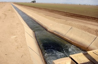 An irrigation channel brings Colorado River water from the All American Canal to a newly planted lettuce field.