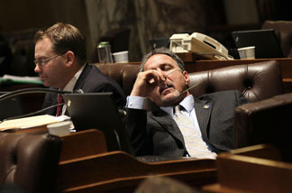 Wisconsin State representatives start to fade as they listen to arguments on one of the expected 200 amendments to Gov. Scott Walker's budget repair bill in the early morning hours on February 24, 2011 in Madison, Wisconsin.