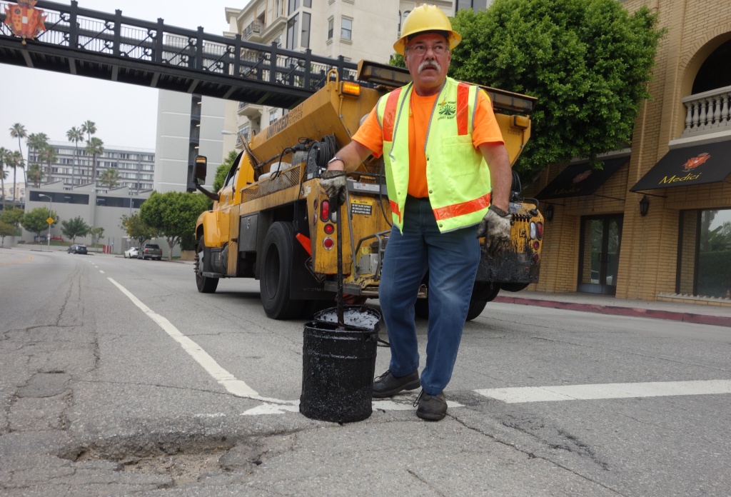 Pothole filling 8th & Bixel Los Angeles city worker Hugo Vasquez reviews a pothole that needs filling at 8th Street and Bixel Ave. downtown.