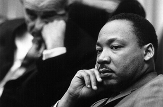 Rev. Martin Luther King Jr. with President Lyndon B. Johnson in the background March 18, 1966 at the White House.