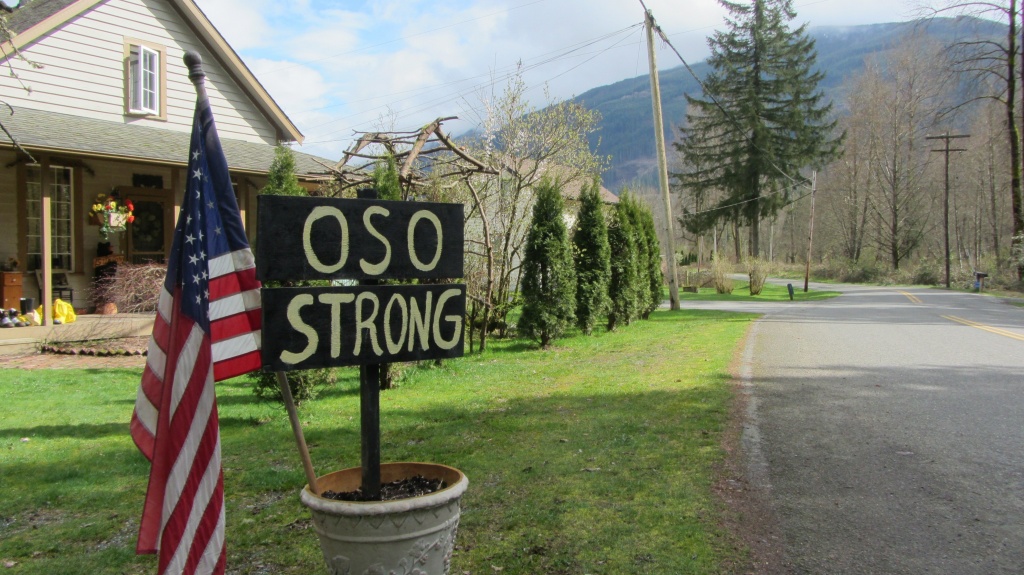 US-LANDSLIDE-TOWNS-FORESTRY A sign and the American flag are seen in Oso, Washington on March 31, 2014. 'We're still in shock, really,' says Ben Sullivan. As the likely death toll from the monster landslide in the picture postcard valley town of Oso climbs into the dozens, that's a common feeling round here, more than a week after the catastrophe.