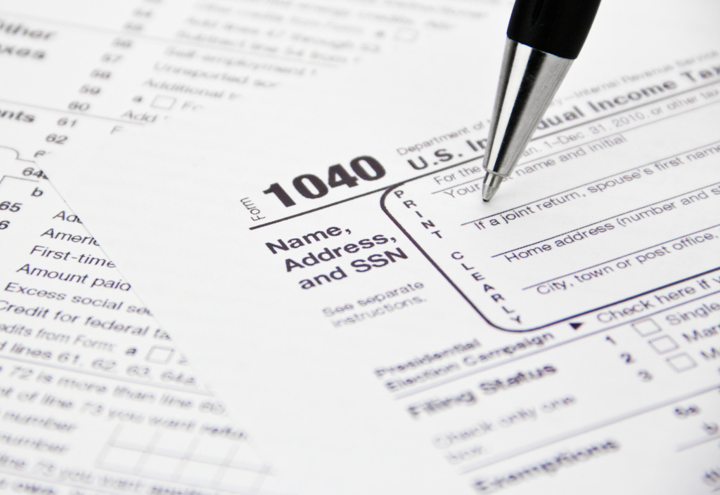 This year's federal tax filing deadline is April 15. IRS 1040 Tax Form Being Filled Out