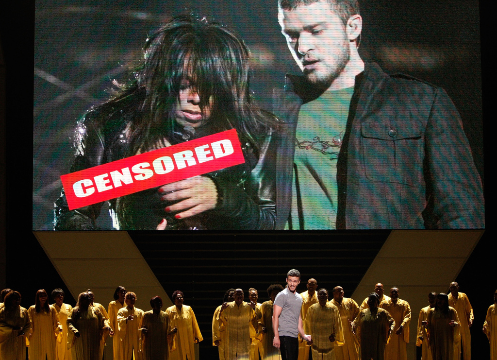 2008 ESPY Awards - Show LOS ANGELES, CA - JULY 16: Host Justin Timberlake stands onstage in front of a video of himself and Janet Jackson from Super Bowl XXXVIII onstage at the 2008 ESPY Awards held at NOKIA Theatre L.A. LIVE on July 16, 2008 in Los Angeles, California. The 2008 ESPYs will air on Sunday, July 20 at 9PM ET on ESPN. (Photo by Kevin Winter/Getty Images)