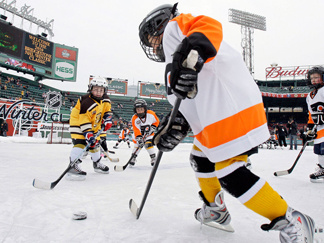 Youth teams play on an auxiliary outdoor rink before the 2010 New Year's Day Winter Classic NHL hockey game. New research shows that young players in leagues that allow checking are much more likely to suffer concussions and serious injuries than kids who play in leagues that ban it.