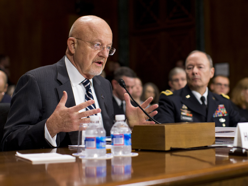 National Intelligence Director James Clapper, left, accompanied by National Security Agency Director Gen. Keith Alexander, testifies on Capitol Hill in Washington on Wednesday.
