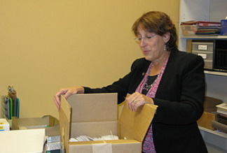 Illinois State Rep. Sandy Cole unpacks boxes and arranges her new district office, after being evicted from her longtime office because the state fell so far behind in paying the rent.
