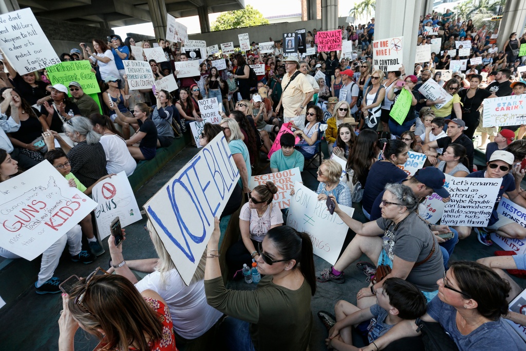 US-SCHOOL-SHOOTING-PROTEST Protesters hold signs at a rally for gun control at the Broward County Federal Courthouse in Fort Lauderdale, Florida on February 17, 2018.