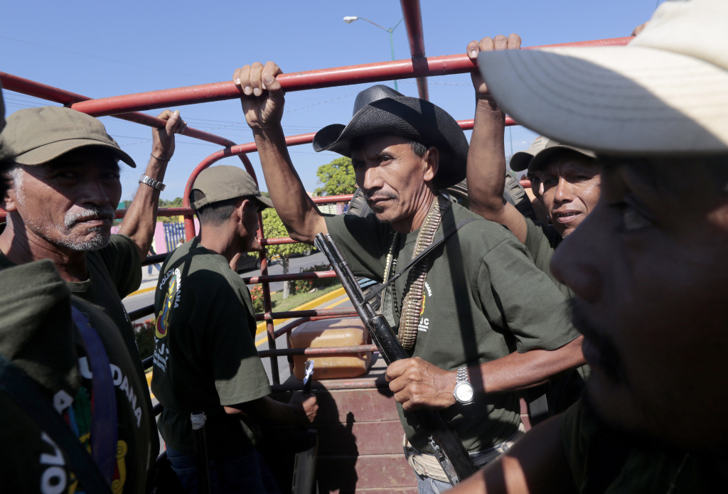 MEXICO-VIOLENCE-COMMUNITY-VIGILANTE-ANNIVERSARY Armed residents take part in a march for the first anniversary of the citizen's vigilante groups, in Ayutla de los Libres, on January 5, 2014, in the southeastern state of Guerrero, Mexico. Hundreds of civilians armed with rifles, pistols and machetes decided to provide security for the communities of Guerrero, creating a vigilante force, following robberies, kidnappings and murder by gangs. Guerrero, home to the Pacific resort town of Acapulco, has been one of the states hardest hit by Mexico's drug violence, which has left more than 70,000 people killed across the country since 2006.