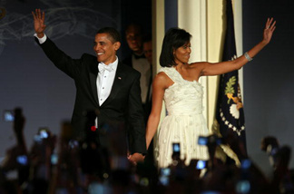 U.S President Barack Obama and his wife First Lady Michelle Obama arrive on stage during MTV & ServiceNation: Live From The Youth Inaugural Ball at the Hilton Washington on January 20, 2009 in Washington, DC. Obama returns to MTV for a town hall meeting on the evening of October 14 to re-engage younger voters.