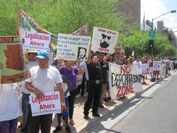 Protesters rally across the street from the downtown Phoenix office of Maricopa County Sheriff Joe Arpaio last July 29, the day that parts of SB 1070 went into effect.
