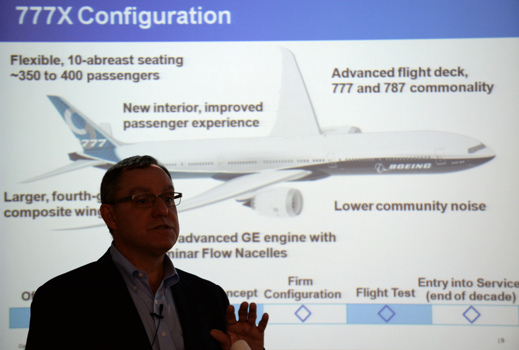 JAPAN-US-AVIATION-COMPANY-BOEING Boeing vice president and general manager of airplane development, Scott Francher speaks about the company's future airplane, the Boeing 777X (illustrated at back) during a press briefing at the Boeing Tokyo office on August 2, 2013. Francher announced the company's next generation Dreamliner line-ups.