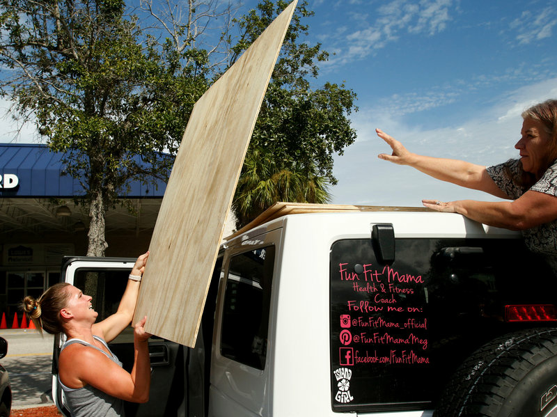 gettyimages-843059512-2ebbc28f2c8839951c1cad514aa23153d7a49795-s800-c85.jpg Megan Daniel (left) gets a hand from a stranger, Delene Cole, as she loads plywood she intends to use as storm shutters ahead of Irma on Tuesday in St. Petersburg, Fla.