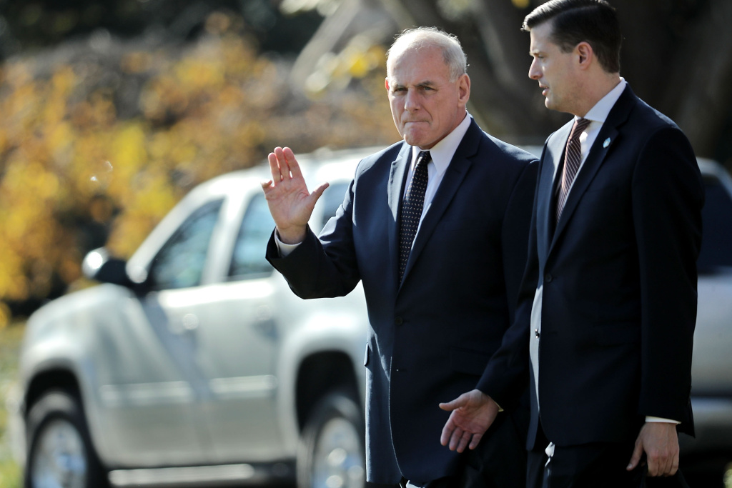 President Trump Departs White House En Route To St. Charles, Missouri White House Chief of Staff John Kelly (left) waves to journalists as he and Staff Secretary Rob Porter (right) leave the White House on November 29, 2017.