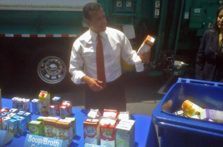 Los Angeles Mayor Antonio Villaraigosa tosses food and beverage cartons into a recycling bin near Fresco Community Market in L.A.