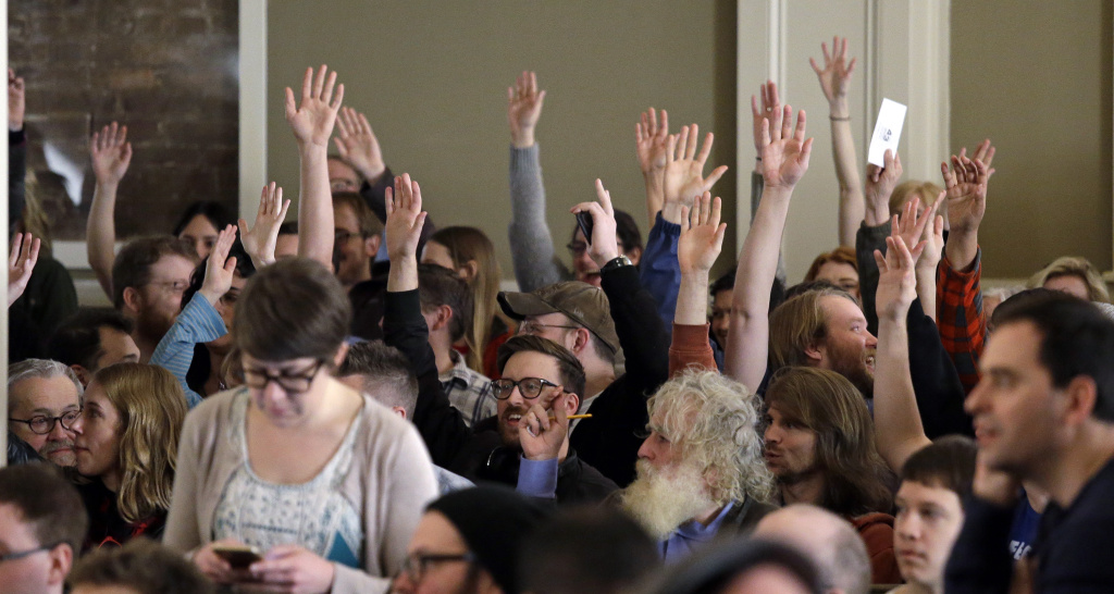 Washington Caucuses Democrats Hands are raised during a vote at a Democratic caucus on March 26, 2016, in Seattle. Democrats caucused statewide in support of either Hillary Clinton or Bernie Sanders.