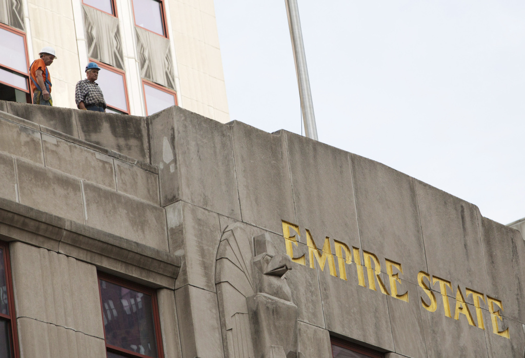 11 Shot, One Killed In Shooting By NYC's Empire State Building Workers look over the scene of a shooting near the Empire State Building August 24, 2012 in New York City. According to reports, two people are dead, including the suspected shooter, and eight people were wounded in the morning shooting that is being described as stemming from a workplace dispute near the Empire State Building.