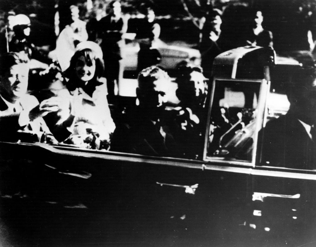JFK In Dallas Motorcade President John F. Kennedy and his wife Jacqueline Kennedy ride with secret agents in an open car motorcade shortly before the President was assassinated in Dallas, Texas, November 22, 1963.