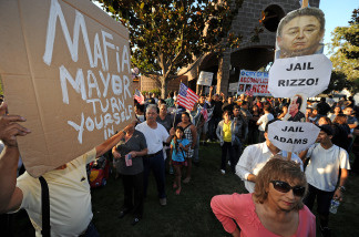 Mercer 10519 Residents of the City of Bell who are calling for the ouster of city officials gather outside a Bell city council meeting in Bell, California.