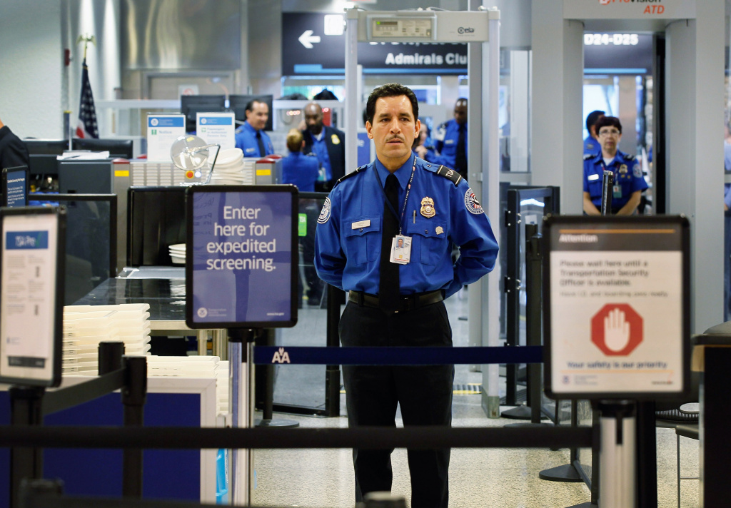 FBI's A TSA agent waits for passengers to use the TSA PreCheck lane being implemented by the Transportation Security Administration at Miami International Airport on October 4, 2011.