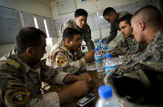 An Iraqi army officer talks to U.S. soldiers during an exchange of intelligence June 2 at an Iraqi army base near Al Guwair, south of Mosul, Iraq.