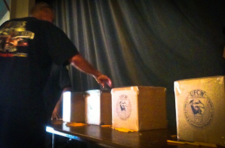 Grocery store worker casts his ballot.