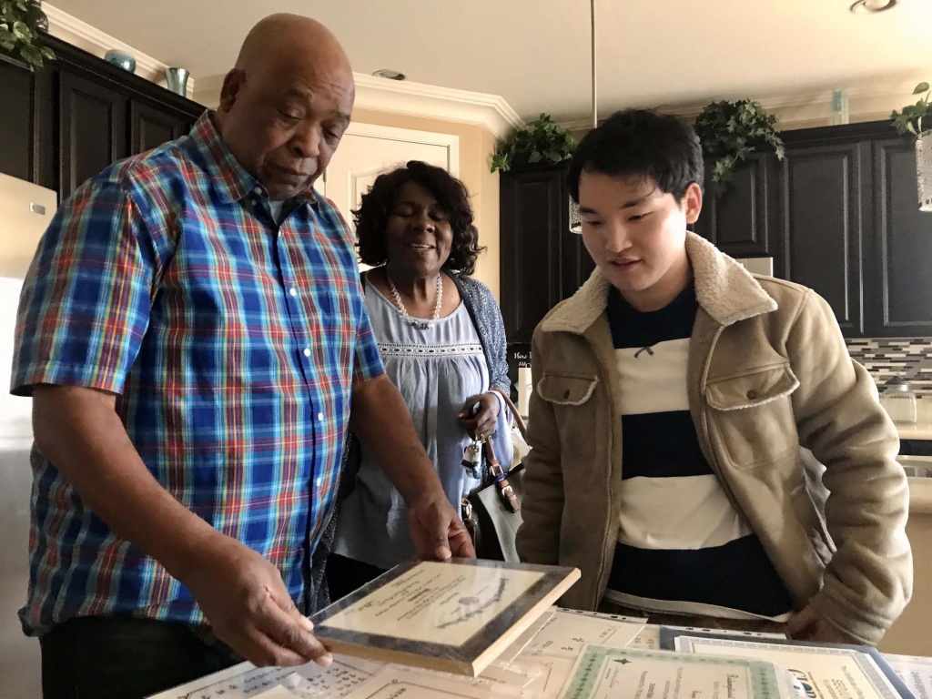 Seojun Lee Seojun Lee (right) looks over some of his school and ROTC documents with his ROTC instructor, retired Army Lt. Col. James Gardner and Gardner's partner, Beverly Meeks.