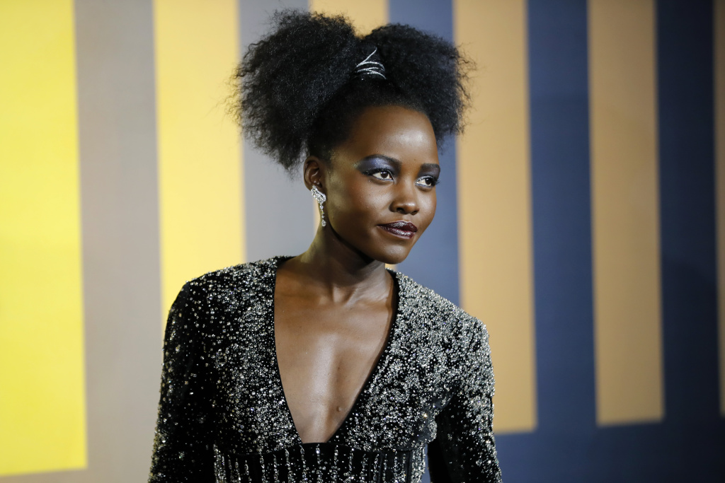 BRITAIN-ENTERTAINMENT-CINEMA Actress Lupita Nyong'o poses on arrival for the European Premiere of 'Black Panther' in central London on February 8, 2018.