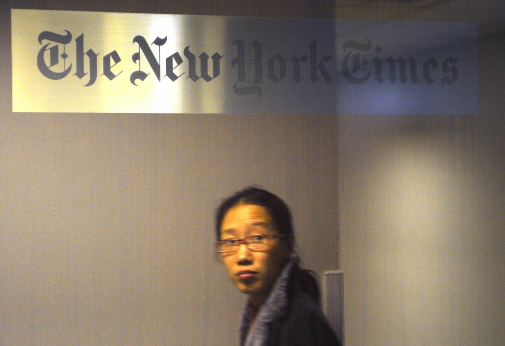 CHINA-POLITICS-CORRUPTION A woman walks past the New York Times office in Shanghai on October 30, 2012. Lawyers for relatives of Chinese Premier Wen Jiabao have hit back at an 'untrue' New York Times article which alleged the family has accumulated vast wealth, a report said.