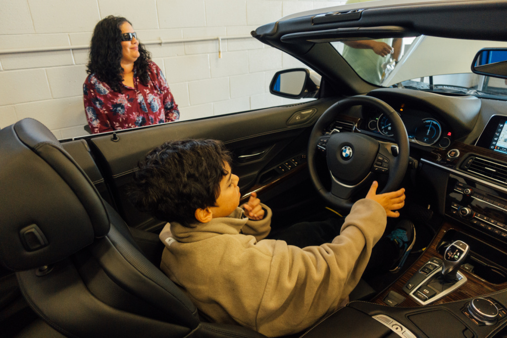 Lizzie Lopez and son BMW MSTEP Opening Lizzie Lopez and son check out a car at the opening of the BMW MSTEP at Marine Corps Base Camp Pendleton.