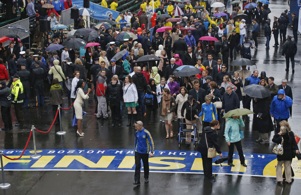 Boston Marathon Bombing Anniversary Family members, friends and survivors of the 2013 Boston Marathon bombing walk to the finish line after a remembrance ceremony on Boylston Street in Boston, Tuesday, April 15, 2014. (AP Photo/Elise Amendola)