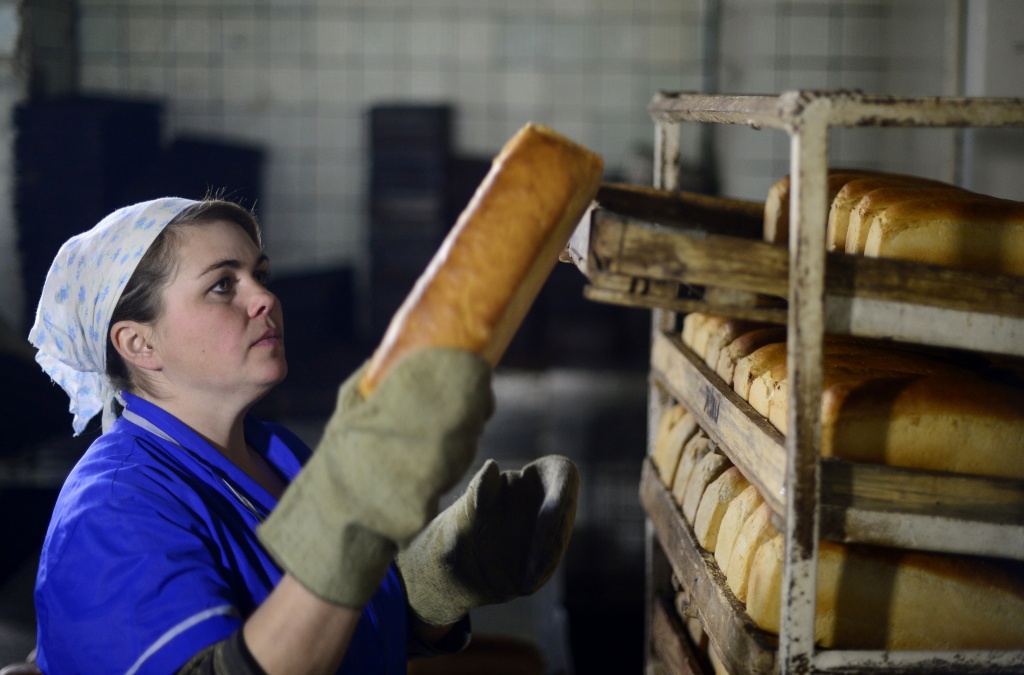 UKRAINE-RUSSIA-CRISIS A worker in a bread factory stacks loaves of bread in Debaltseve, Ukraine on March 9, 2015. The city, captured from Ukrainian troops by soldiers of the self-proclaimed Donetsk People's Republic on February 18, is slowly coming back to life.