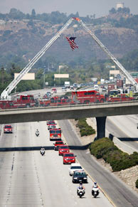 Firefighters escort the body of fallen firefighter Capt. Tedmund Hall, one of two firefighters who died in the 226-square-mile Station Fire, to a mortuary in Victorville, California on September 4, 2009 in Glendale, California.
