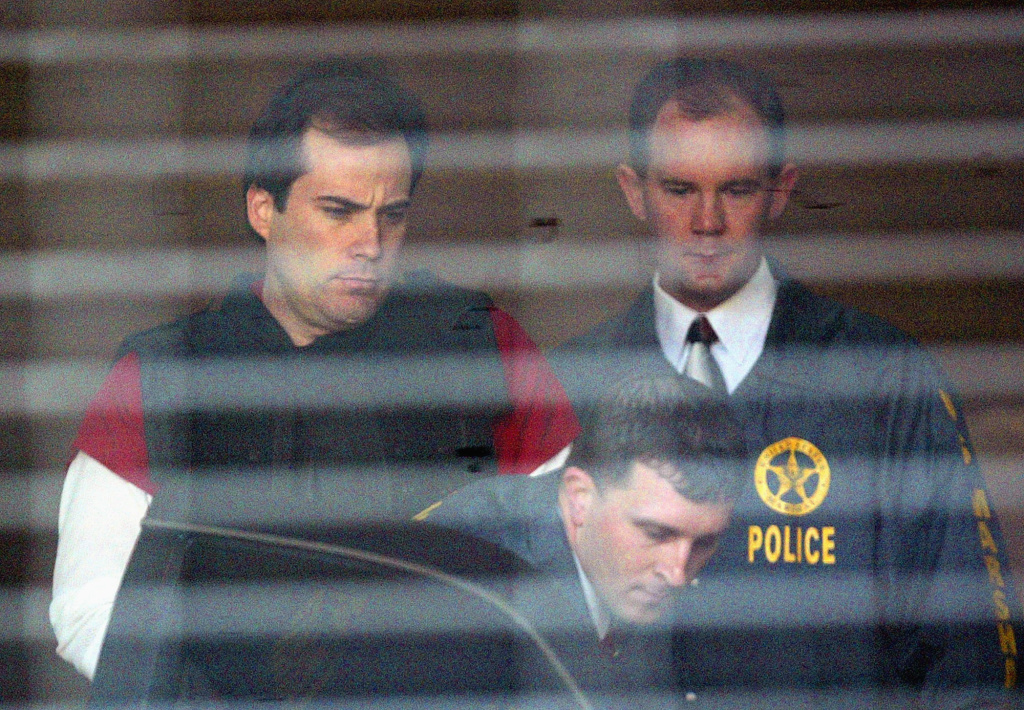 FBI Most Wanted Eric Rudolph, left, is led to a waiting police car by U.S. Marshals as he leaves the Jefferson County Jail for a hearing in Birmingham, Alabama.